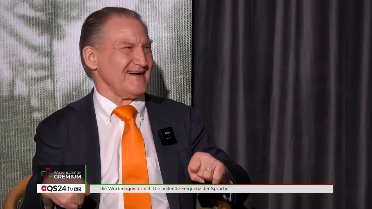 Die Wortereignisformel: Die heilende Frequenz der Sprache 4 Alexander Glogg spricht in Nahaufnahme mit orangefarbener Krawatte
